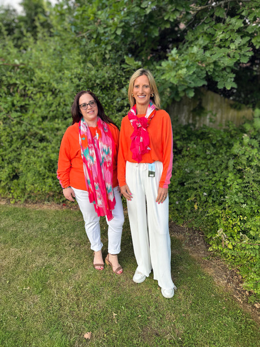 Knitted pullover in orange and pink